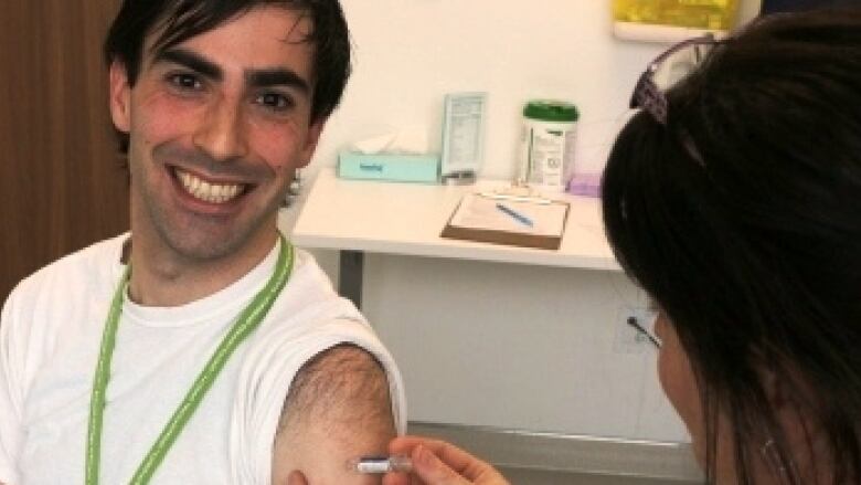 Dr. Matthew Tenenbaum, pictured here receiving a flu shot, is the associate medical officer of health with Wellington-Dufferin-Guelph Public Health.