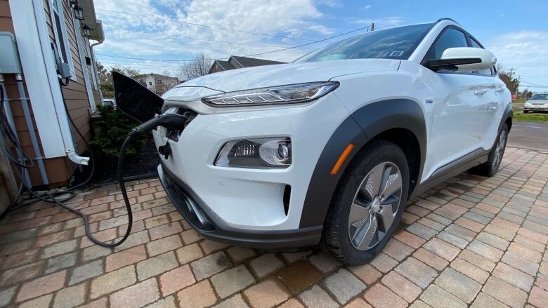 White electric car plugged in.