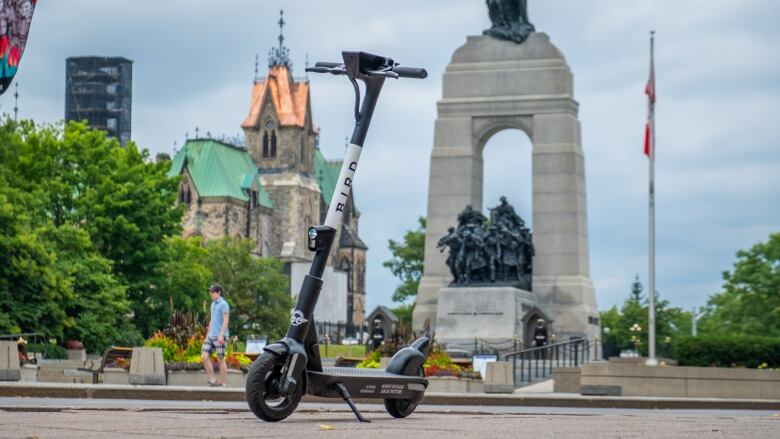 An e-scooter sits in front of the National War Memorial in Ottawa.