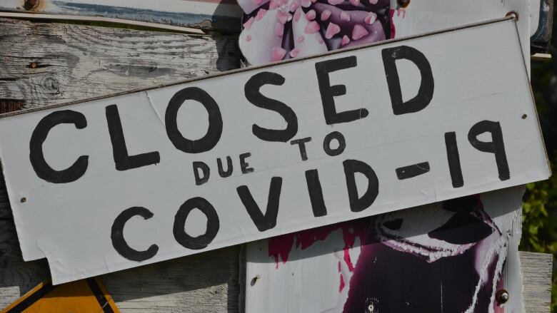 A sign reads 'Closed due to COVID-19'