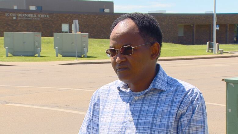 Jibril Ibrahim, president of the Somali Canadian Cultural Society, in a school parking lot.