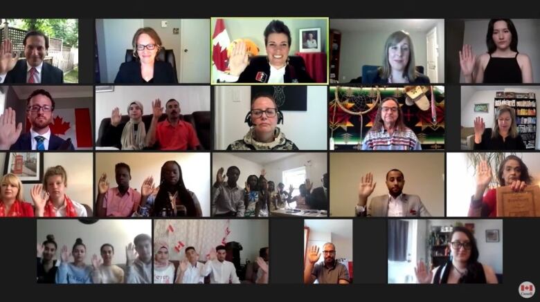 Several people take the oath of citizenship on a videoconference call.