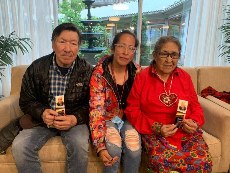 Raphal Andr's father, Daniel Andr, left, sister Carmen Andr and mother Suzanne Chemaganish sitting on a couch.