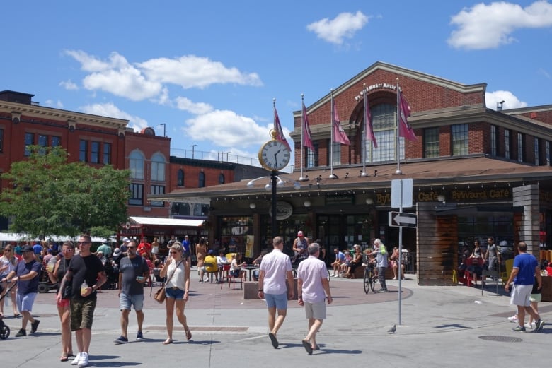 People walk in front of Ottawa's ByWard Market on July 4, 2021. 