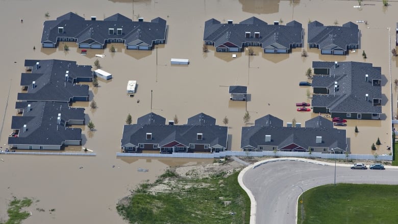 An aerial photograph of houses surrounded by flood waters