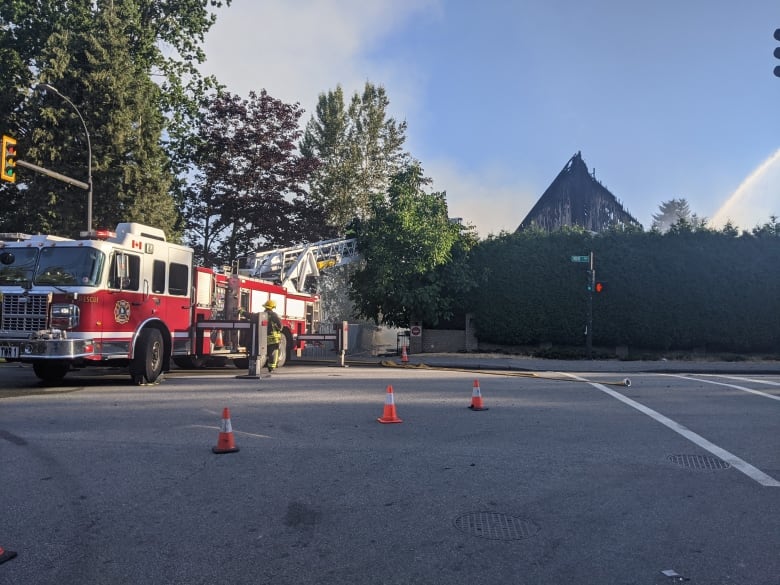 A fire truck is seen with a church in the background.