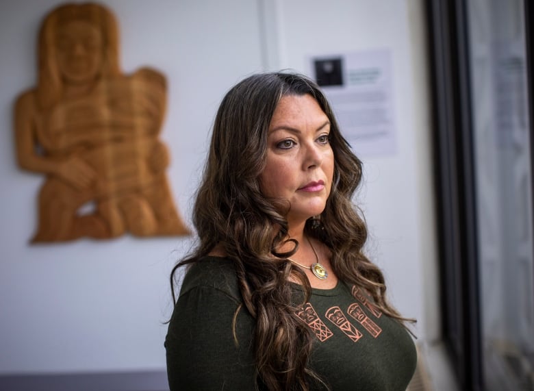 A portrait of an Indigenous woman with long hair. 