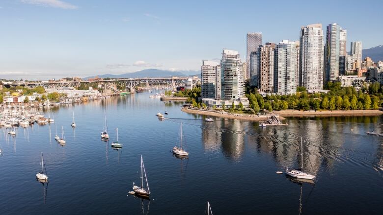 A number of skyscrapers and boats are seen along False Creek in downtown Vancouver in this aerial shot.