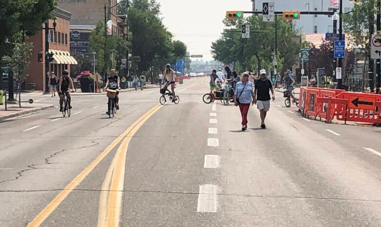 An open road is pictured with pedestrians and cyclists.