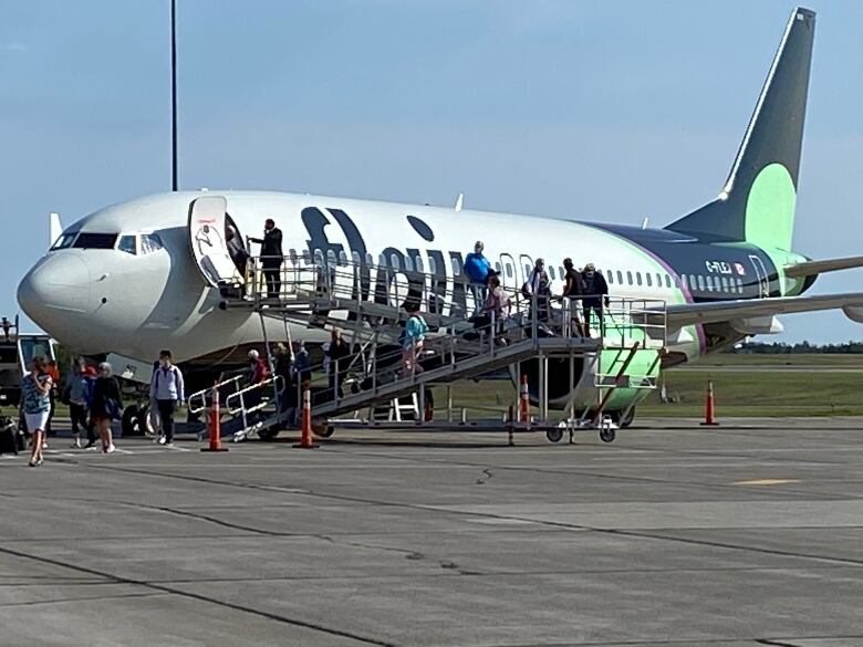 people getting off airplane