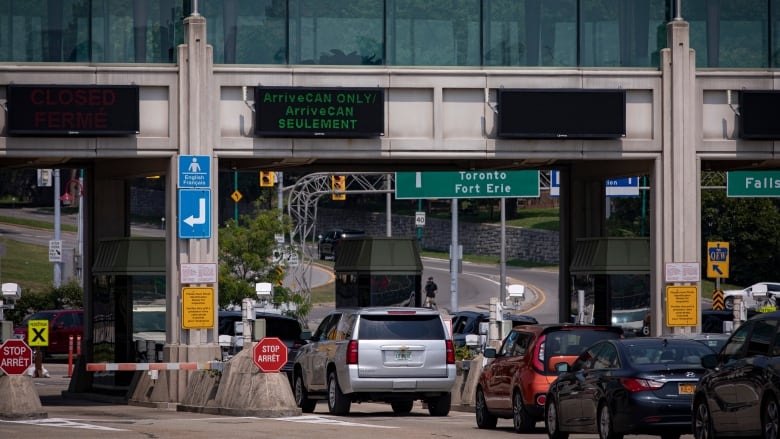 Cars line up at a customs booth at the Canada-U.S. border in Niagara Falls.