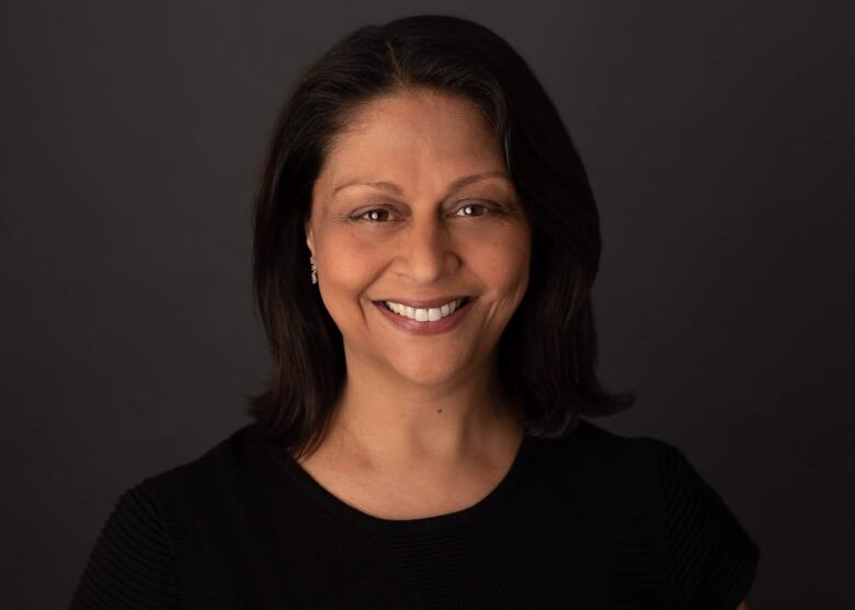 A smiling woman with dark hair.