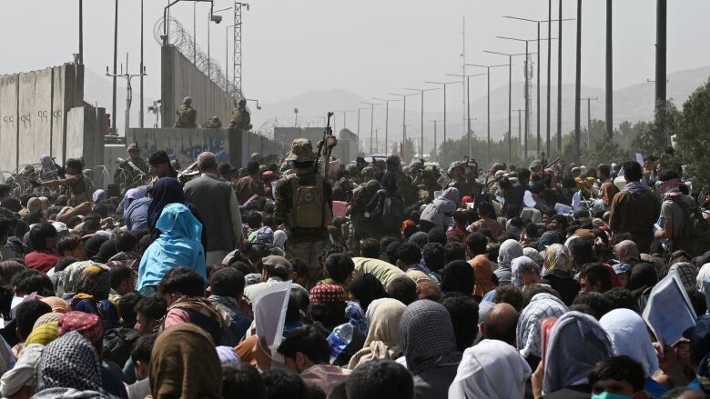 Crowds of people on a raod leading to an airport