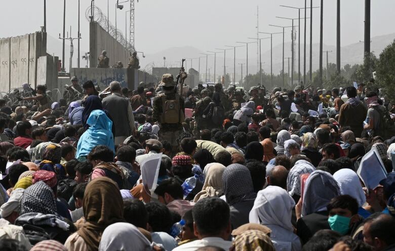 Crowds of people on a raod leading to an airport