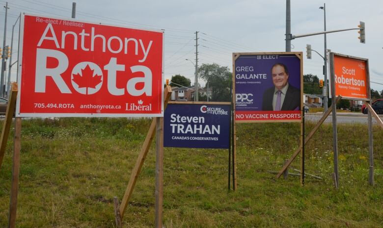 Four election signs at an intersection