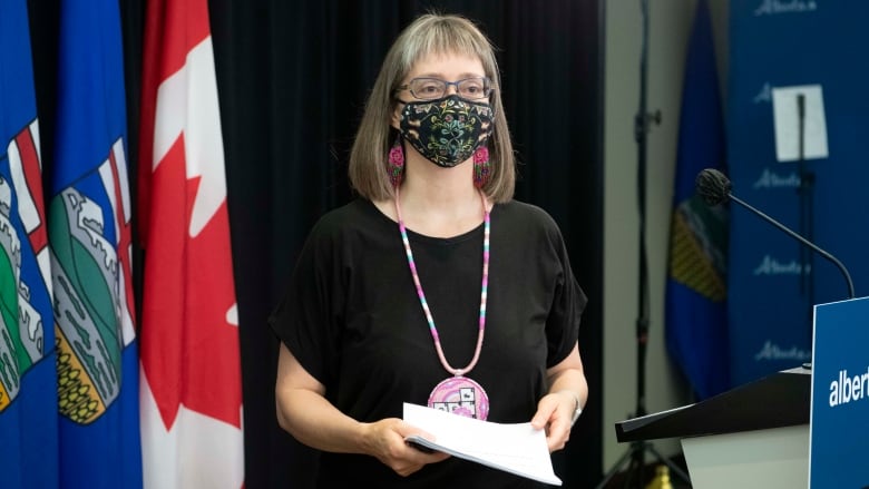 Dr. Deena Hinshaw wears a mask as she walks away from the podium at a press conference.