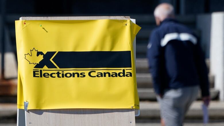 A yellow sign with black text that reads 'Elections Canada.' 