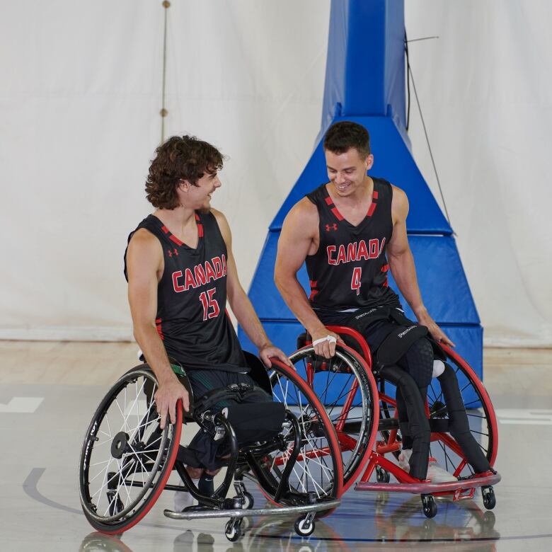 Garrett Ostepchuk (left) and Nik Goncin (right) playing wheelchair basketball.