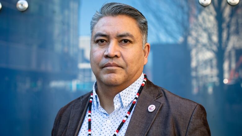 Man stands with blue background