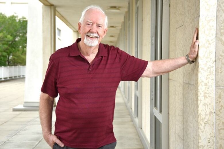 An older man poses for a photo.