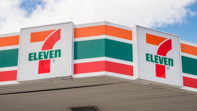 Horizontal orange, green and red lines with a '7-Eleven' sign.