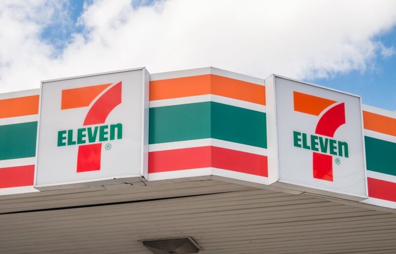 Horizontal orange, green and red lines with a '7-Eleven' sign.