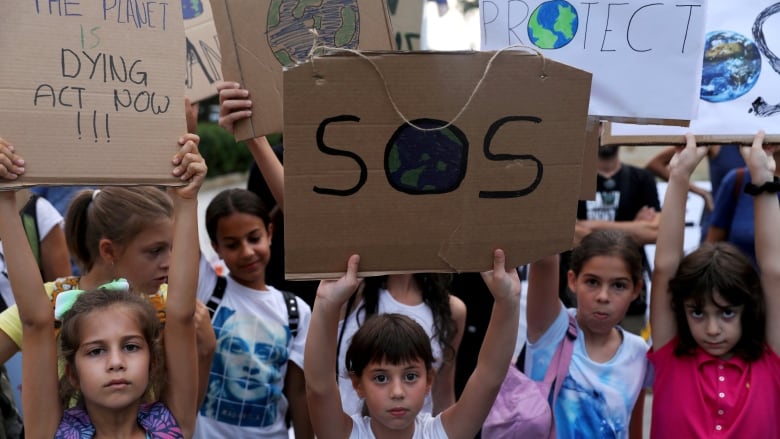 Children hold placards during a climate change rally