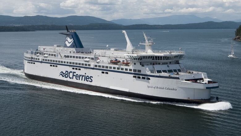 A ship with B.C. Ferries branding sails on the open sea.