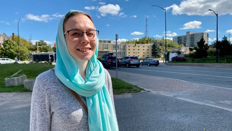 Evie Ali outside in a baby blue hijab