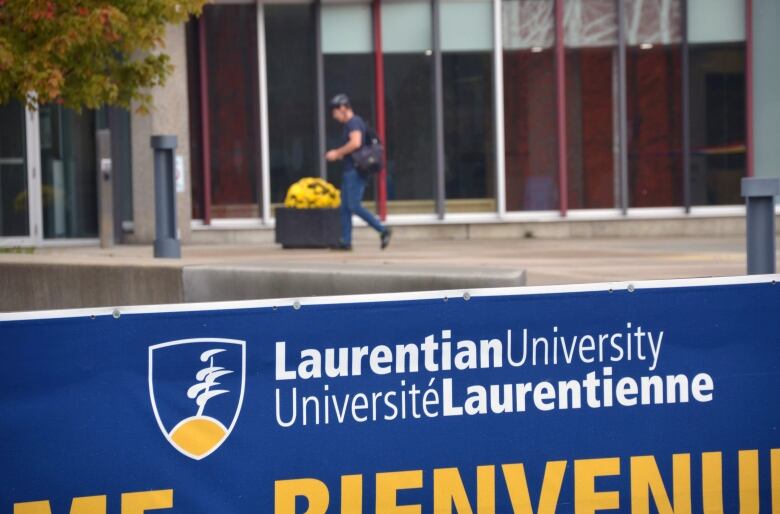 Student with helmet walking into Laurentian University