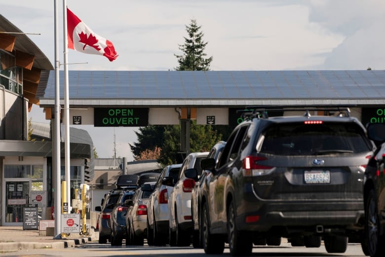 People cross the U.S.-Canadian border after Canada opened the border to vaccinated Americans in Blaine, Washington, U.S., on Aug. 9, 2021.