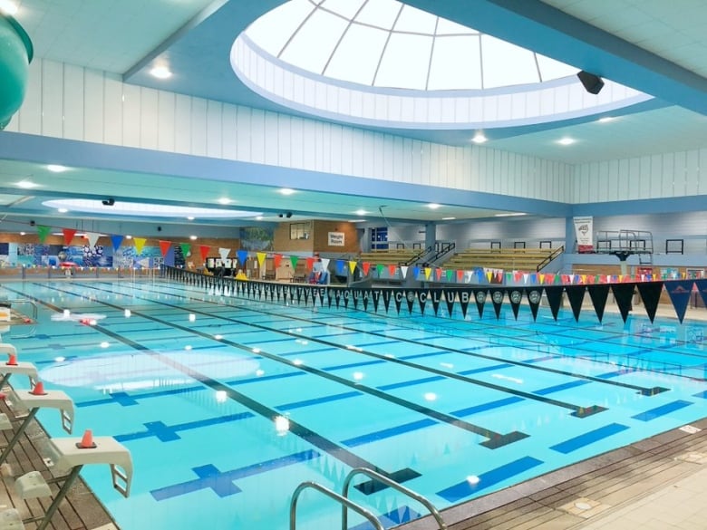 A large pool under a domed sunroof with multiple low diving platforms.