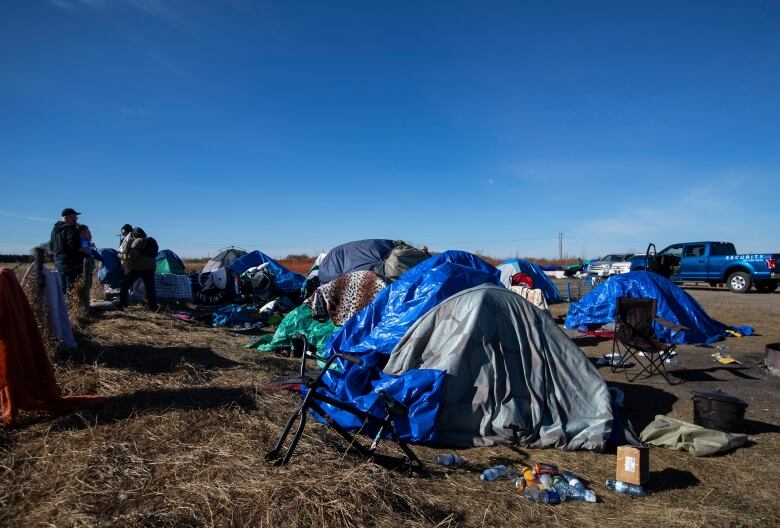 Tents in a prairie field.