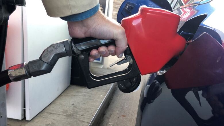 hand holds gas pump