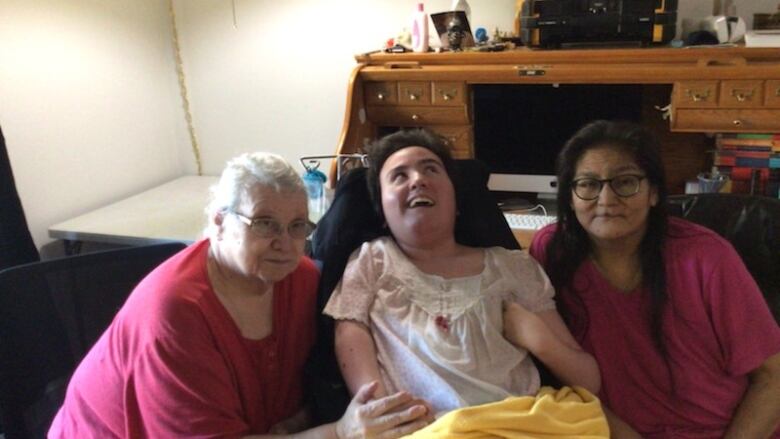 Three women sitting infront of a camera