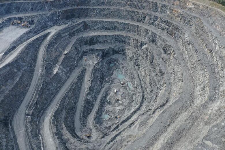 An aerial image of an open pit gold mine.