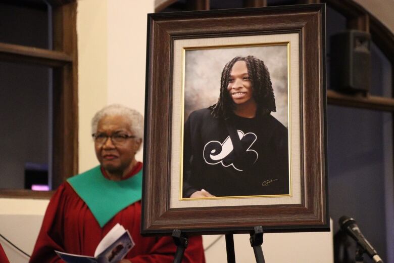 Woman stands behind frame of Jannai Dopwell-Bailey