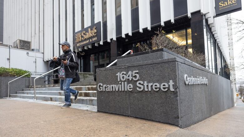 The front entrance of an office building on a street corner.