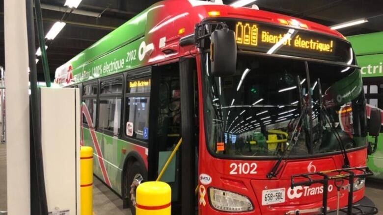 A photo of a new electric OC Transpo bus sits in a garage during a photo op Nov. 26, 2021.