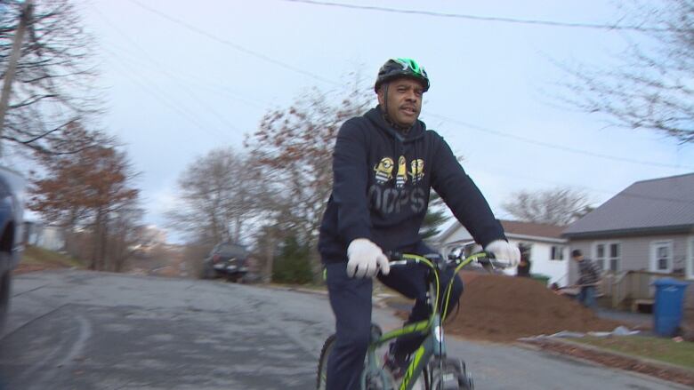 A Black man on a bicycle