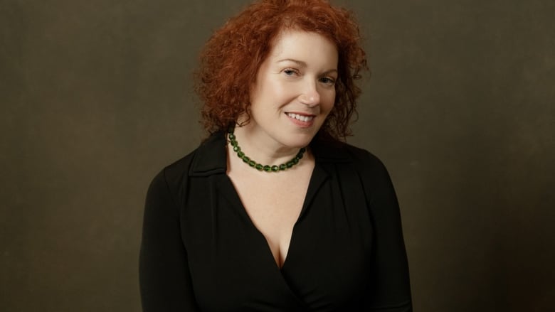 A woman with red curly hair.