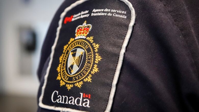 A close up picture of a Canada Border Services Agency badge.