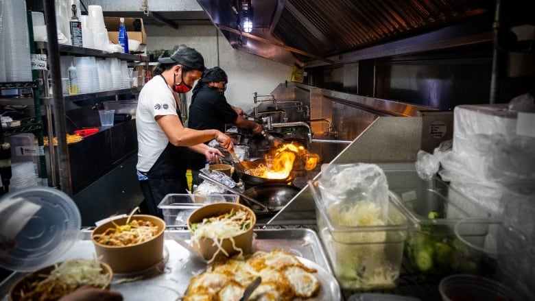 Kitchen staff from Pai, a Thai restaurant in Toronto, prepare orders in a rental space at Kitchen Hub, a ghost kitchen in Etobicoke, Ontario.