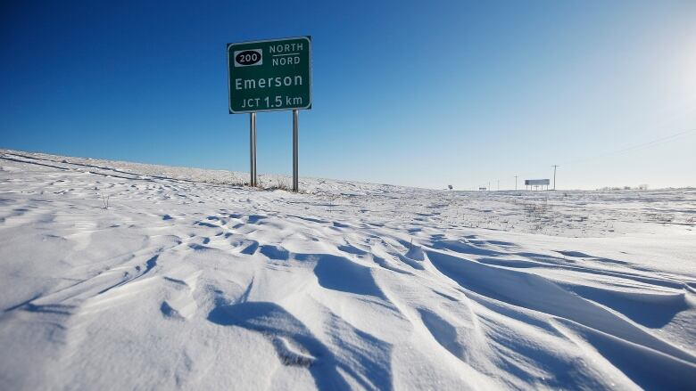 A green highway sign reading 