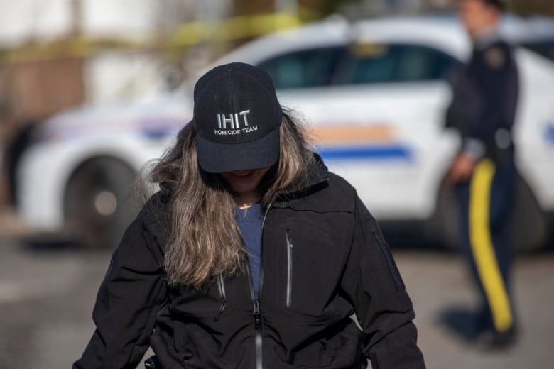 A police officer with a hat that reads 'IHIT Homicide Team'.