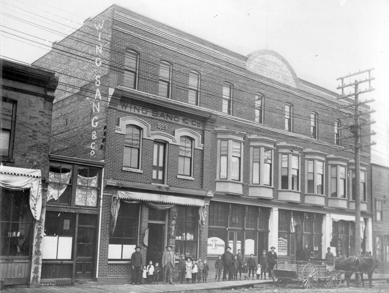 An old black and white photo shows a brick building in chinatown. 