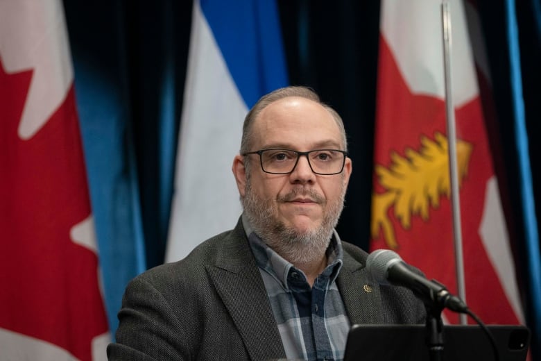 man speaking at city hall