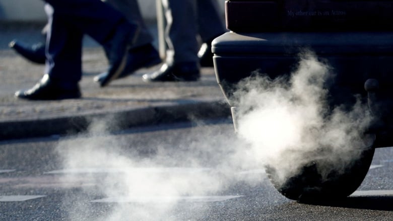 A close-up view of the cloud of white exhaust coming out of a tailpipe