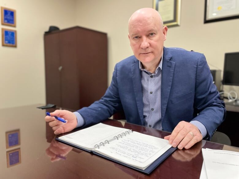 White-haired man in business suit. 