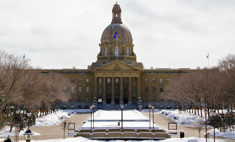 The Alberta legislature, a large domed building, pictured in winter.